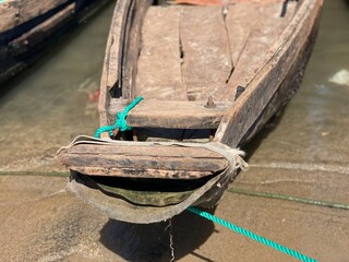 Close Up Front View of Traditional Wooden Boat Bow Tied with Green Rope © Islam