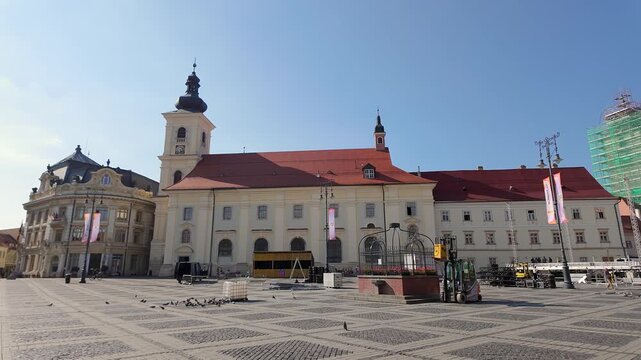 Holy Trinity Roman Catholic Church and historic buildings across Piata Mare in Sibiu Romania