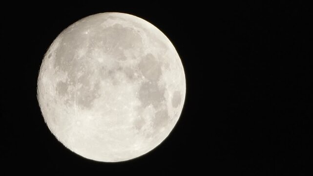 Moon astronomy space capturing a detailed view of the lunar surface with craters and highlights against the pitch black night sky
