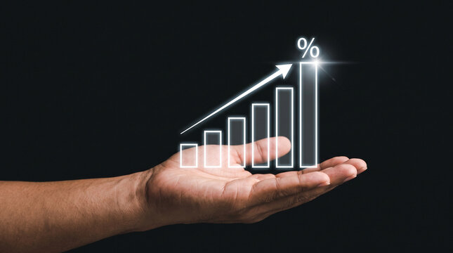 Hand holding a glowing bar chart with an upward arrow and percentage sign, representing business growth, financial success, and investment progress