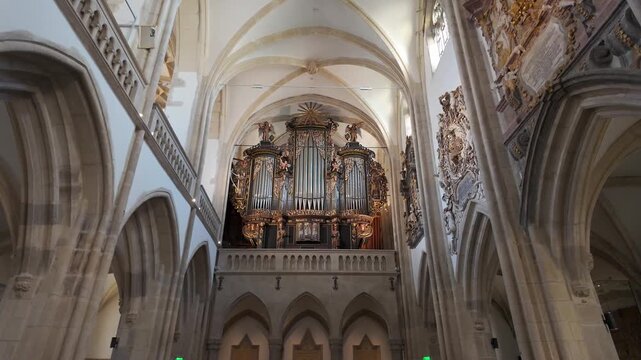 Historic pipe organ framed by Gothic arches inside Saint Mary Evangelical Cathedral in Sibiu Romania