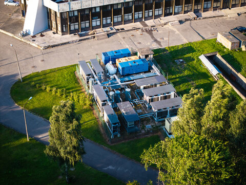 Aerial view of the LVRTC data center hub at the Zakusala TV Tower complex, featuring industrial cooling units and technical infrastructure in Riga, Latvia.
