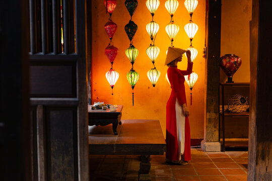 Vietnamese tourist woman in traditional dress with lanterns in hoi an, vietnam