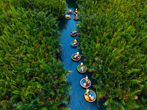 Tourists in basket boats on coconut canal in hoi an, vietnam