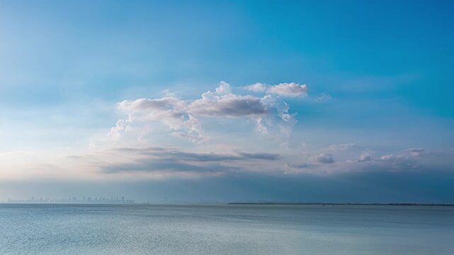 Hefei Chaohu Blue Sky Clouds Timelapse: Rolling Clouds Reflect on Lake with Distant City Silhouette