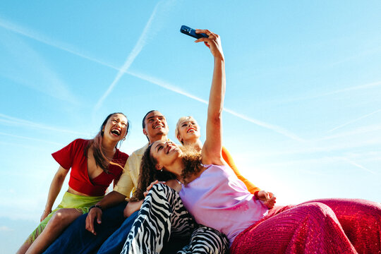 Friends taking a selfie outdoors during summer vacation