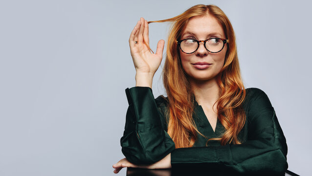 Woman wearing glasses in studio for eyewear fashion