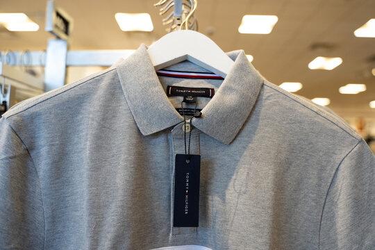 Close up of Tommy Hilfiger polo shirt hanging in retail store. Toronto, Canada - July 30, 2026.