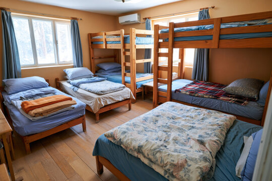 Cozy hostel dormitory room with bunk beds and single beds for travelers