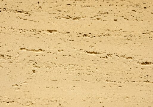 Detailed close-up of pale yellow oolitic limestone facade showing fine grain texture and weathered surface patterns used in historic construction ,close up ,cut stone ,block