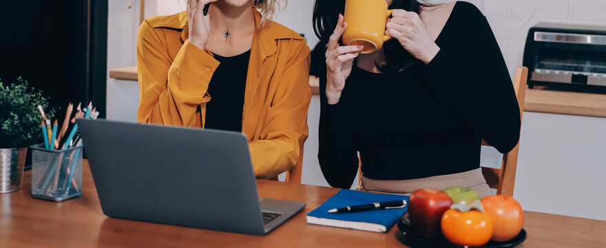Portrait of military mother helping teen daughter with homework and eating lunch