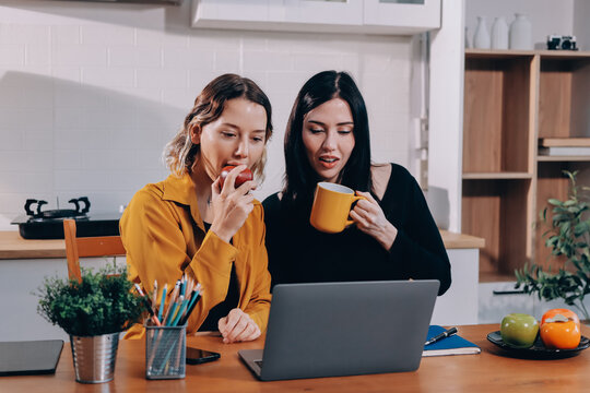Portrait of military mother helping teen daughter with homework and eating lunch