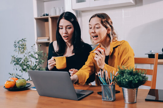 Portrait of military mother helping teen daughter with homework and eating lunch