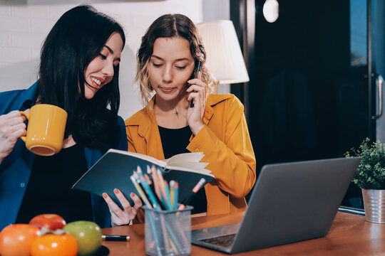 Portrait of military mother helping teen daughter with homework and eating lunch