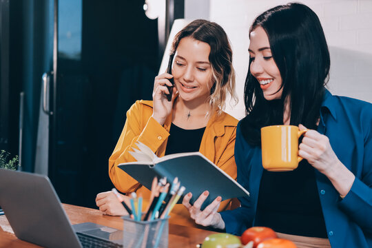 Portrait of military mother helping teen daughter with homework and eating lunch
