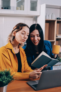 Portrait of military mother helping teen daughter with homework and eating lunch