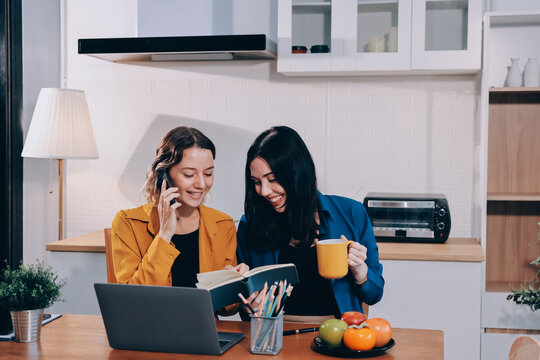 Portrait of military mother helping teen daughter with homework and eating lunch