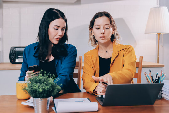 Portrait of military mother helping teen daughter with homework and eating lunch