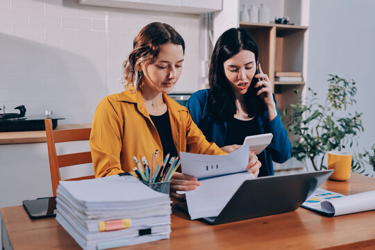Portrait of military mother helping teen daughter with homework and eating lunch