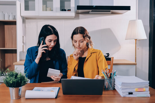 Portrait of military mother helping teen daughter with homework and eating lunch