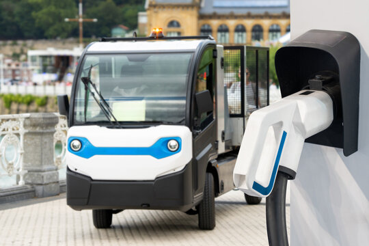 Small urban service electric vehicle with charging station