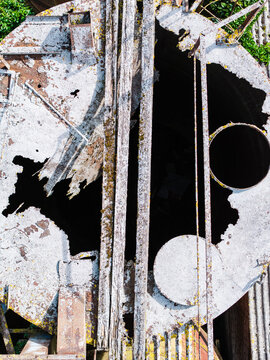 Aerial view of the decaying top of a Soviet-era agricultural silo with rusted metal and weathered surfaces in Kulciems, Talsi Municipality, Latvia.