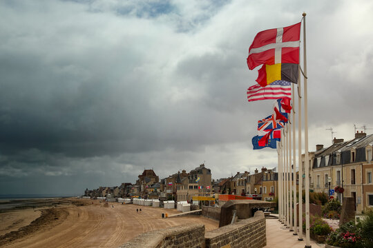 International flags flying along the seafront promenade at Saint Aubin sur Mer Normandy France