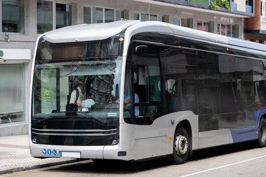 Modern electric city bus driving through a European urban street
