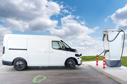 Electric commercial van charging at a modern EV charging station
