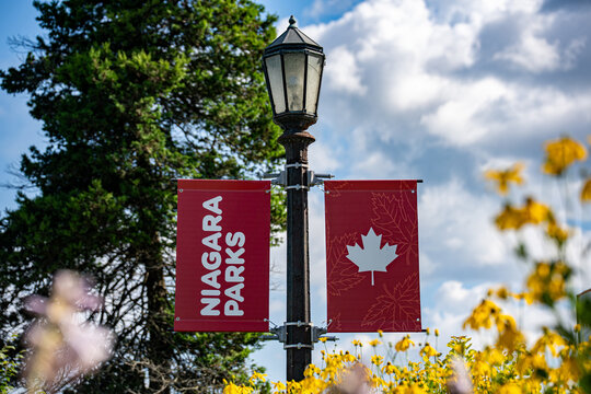 View of Niagara Parks banners with Canadian flag in Niagara Falls. Niagara Falls, Canada - July 30, 2026.