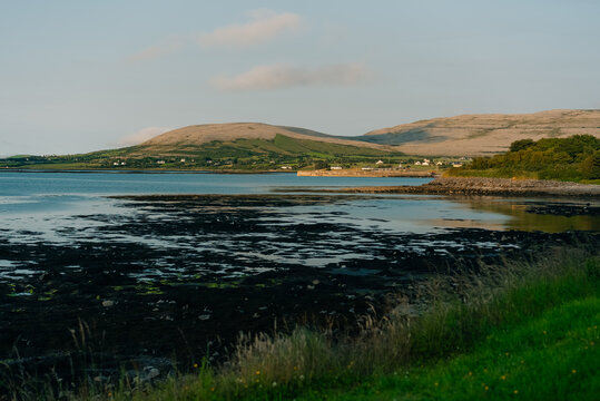 Scenic coastal landscape overlooking a bay in County Clare, Ireland, with rugged shoreline, green countryside and the Atlantic Ocean - County Clare, Ireland - 31 August 2026.