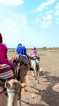 Marrakech, morocco. August 9, 2026. Point of view of a person riding a camel in a caravan. Tourists exploring the agafay desert during a tour near marrakech, morocco