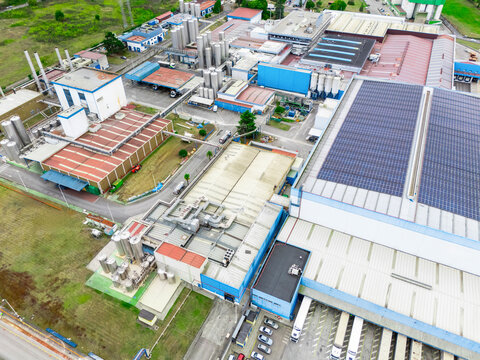 Modern green factory powered by renewable solar energy. Sustainable development in industry