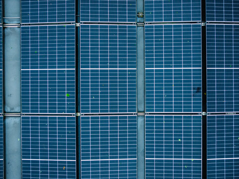 Aerial view of solar panels on a rooftop during a rainy day in Riga, Latvia.