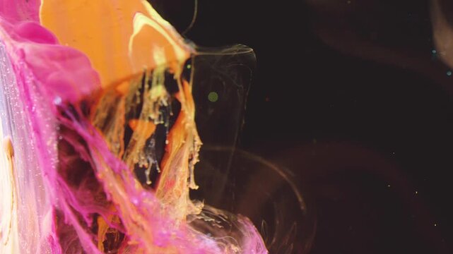 Extreme close-up of thick paint peeling and stretching from left edge, showing layered swaths of magenta, pink, orange and yellow forming glossy ridges, translucent