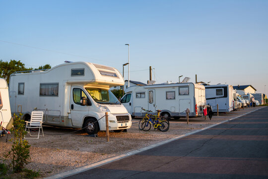 A row of campers in a campsite.