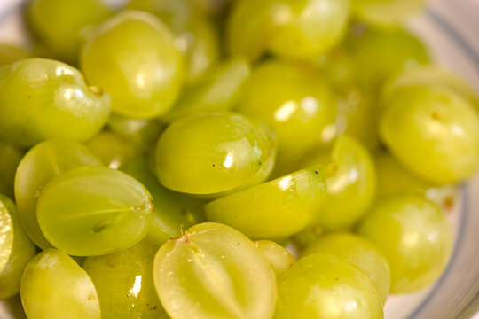 Close-up of grapes cut in half. Domestic kitchen, white grapes, sweet food, ripe, organic, read to eat, season.
