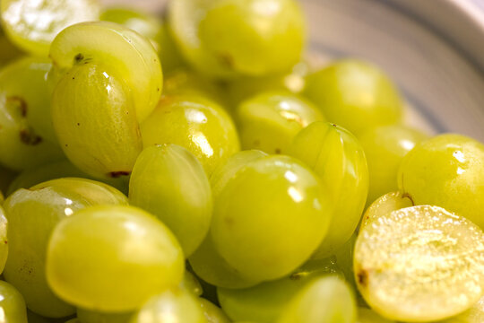 Close-up of grapes cut in half. Domestic kitchen, white grapes, sweet food, ripe, organic, read to eat, season.