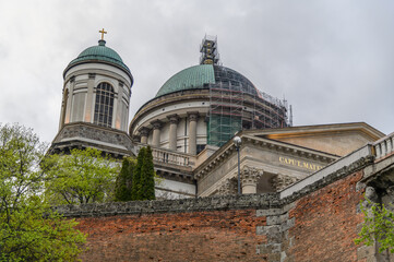Green domes and bell tower of Esztergom Basilica rising above old brick walls, Hungary © Michal Plevko