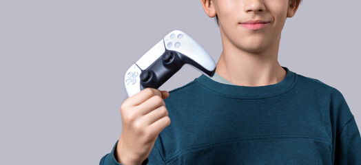 Gamer hand using video game console controller. Playing games concept. Man play a football game with video game controller. Child holding a game controller © Yevhen