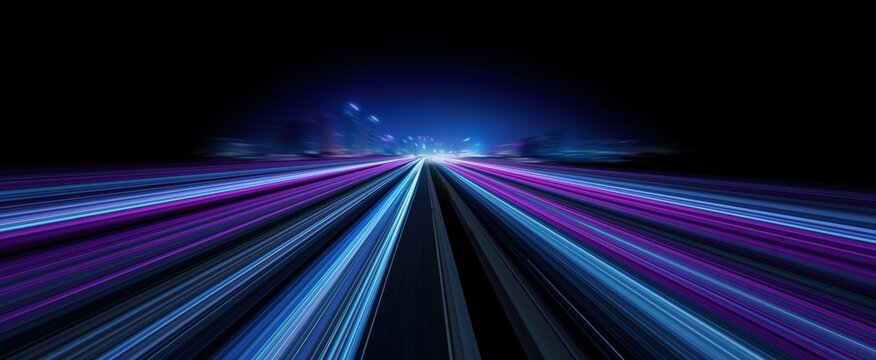 Blue and purple light trails weave along a nighttime urban street. Motion blur suggests velocity and a high-tech atmosphere, perfect for sci-fi cityscape imagery.