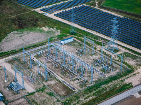 Aerial view of Tume Solar Park featuring rows of solar panels and an electrical substation with power lines in Tume Parish, Tukums Municipality, Latvia.