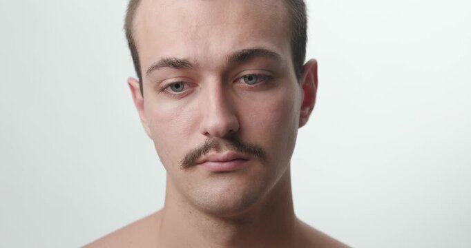 Studio Portrait of Insecure Shy Young Caucasian Man Looking Away