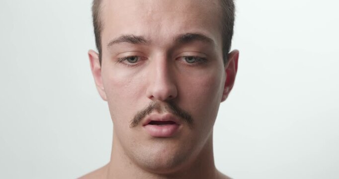 Studio Close-Up Portrait of Anxious Agitated Young Caucasian Man Breathing Open Mouth