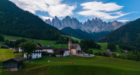 Naklejka premium Landscape village Santa Maddalena in mountain valley at sunset in Dolomites, Italy. St. Magdalena and mountains. Val di Funes 
