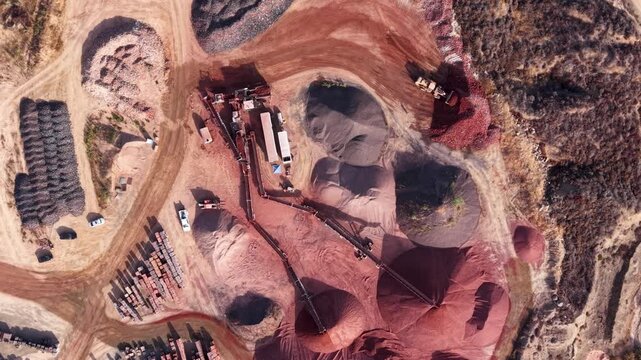 Earth Moving machinery hard at work in this Clay Mining Facility as we look down at the wondrous red clay being processed into Bricks