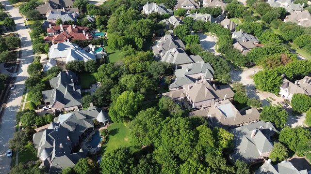 Winding concrete streets link private Starwood estates along Shady Oaks Drive. Sprawling backyard swimming pools accent secluded wooded properties across prestigious Frisco, Texas
