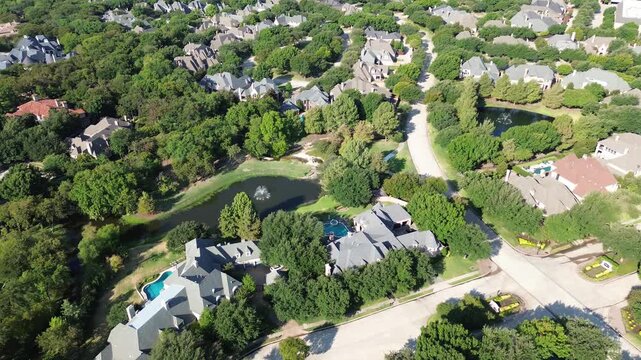 Sprawling retention ponds border custom Starwood estates near Dallas Parkway. Central fountain features anchor neighborhood waterways, displaying suburban master planning across Frisco, Texas