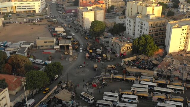 Aerial top down view busy road junction with cars and buses in traffic in African city