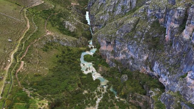 Aerial view of Millpu turquoise pools in a rocky canyon landscape.